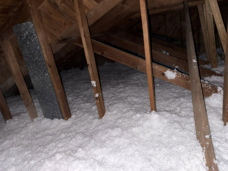 Blown-in insulation being installed in an attic
